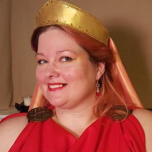 A woman wearing a red dress and a gold crown, representing Hestia.