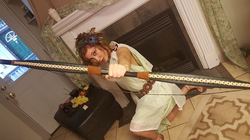 A woman in a toga, shooting a bow, representing Artemis.