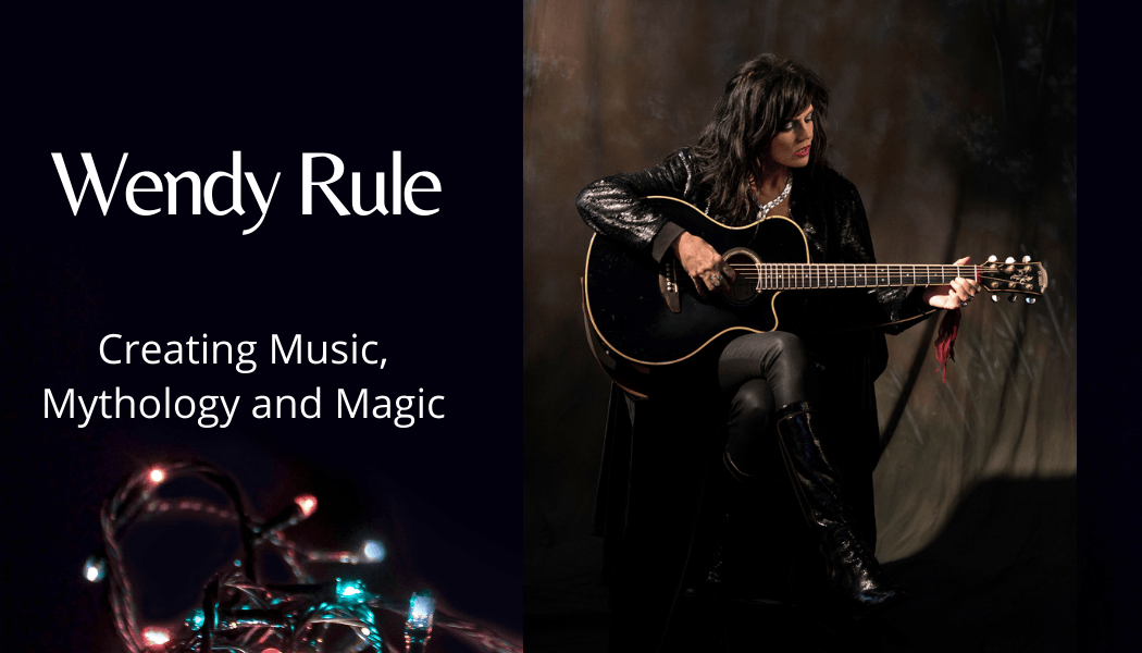 A woman is playing a guitar in a dark room, Wendy Rule.