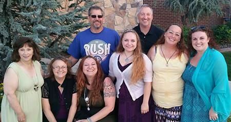 A group of people posing for a picture, members of the Aquarian Tabernacle Church.