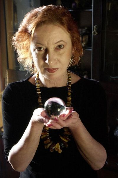 A woman is holding a crystal ball in her hands