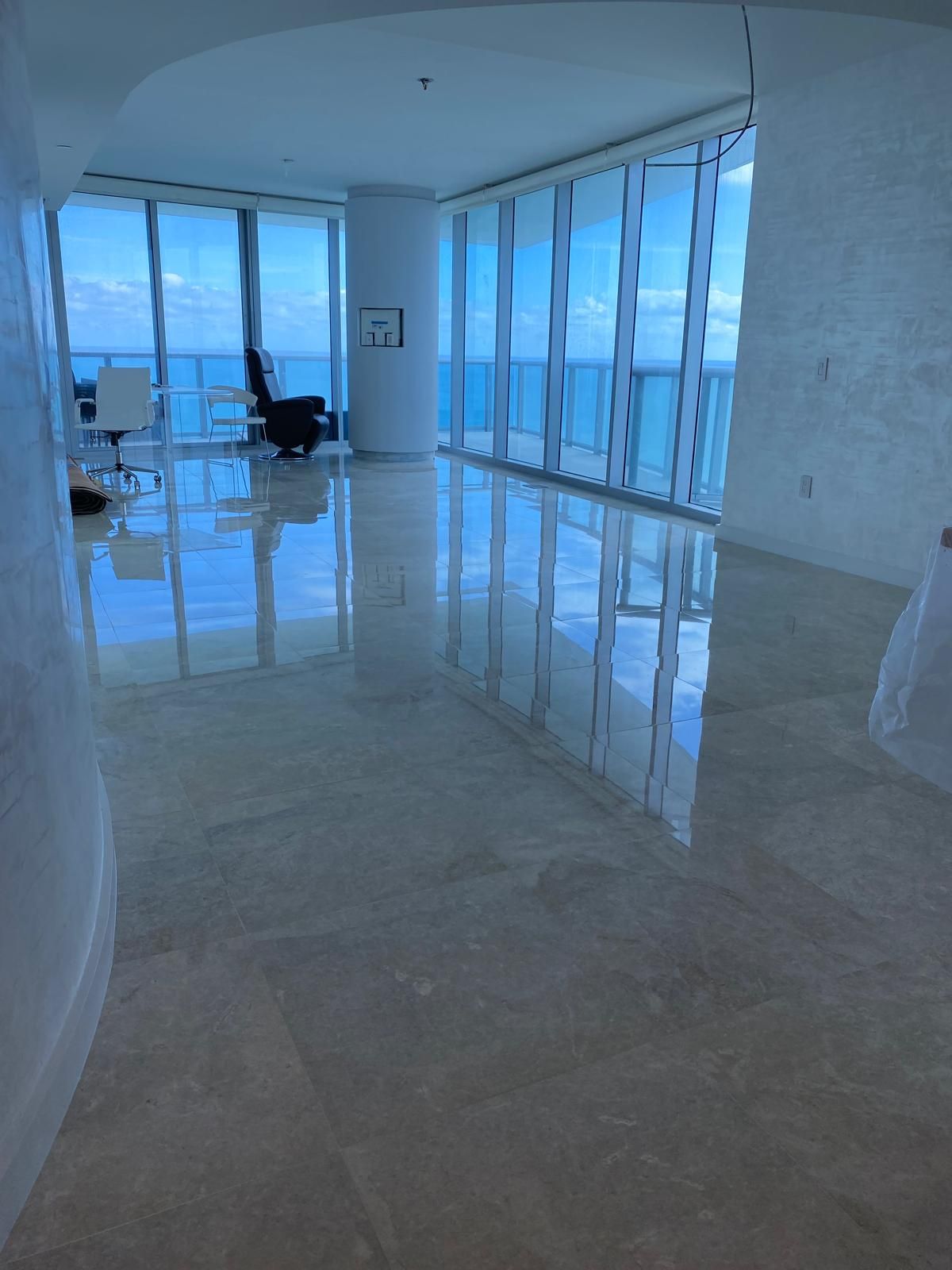 A large room with lots of windows and marble floors