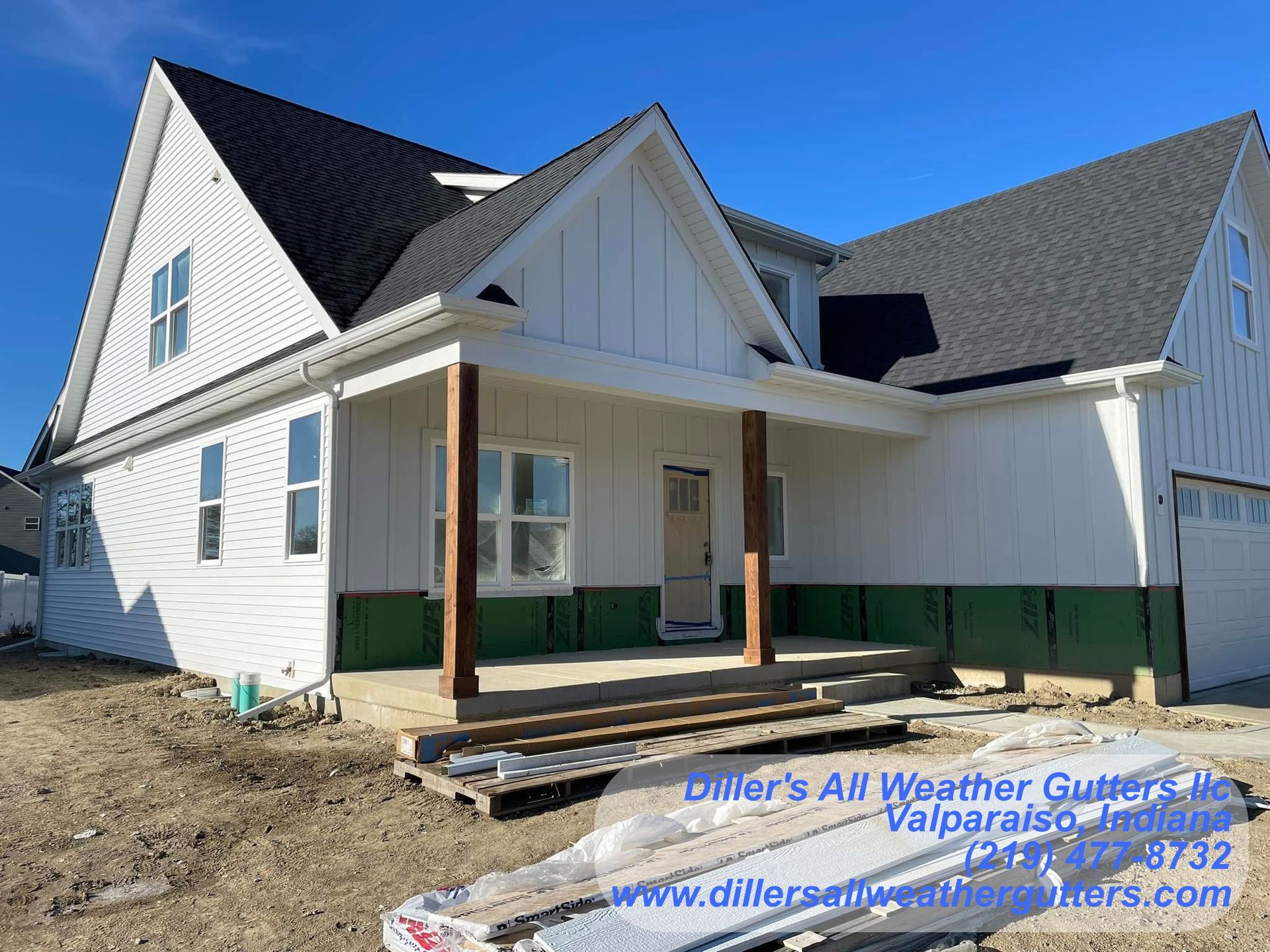 A white house with a black roof is being built.