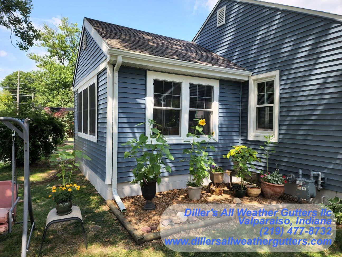 A black garage with two bikes parked in front of it.  Gutter Installation in Valparaiso, Indiana
