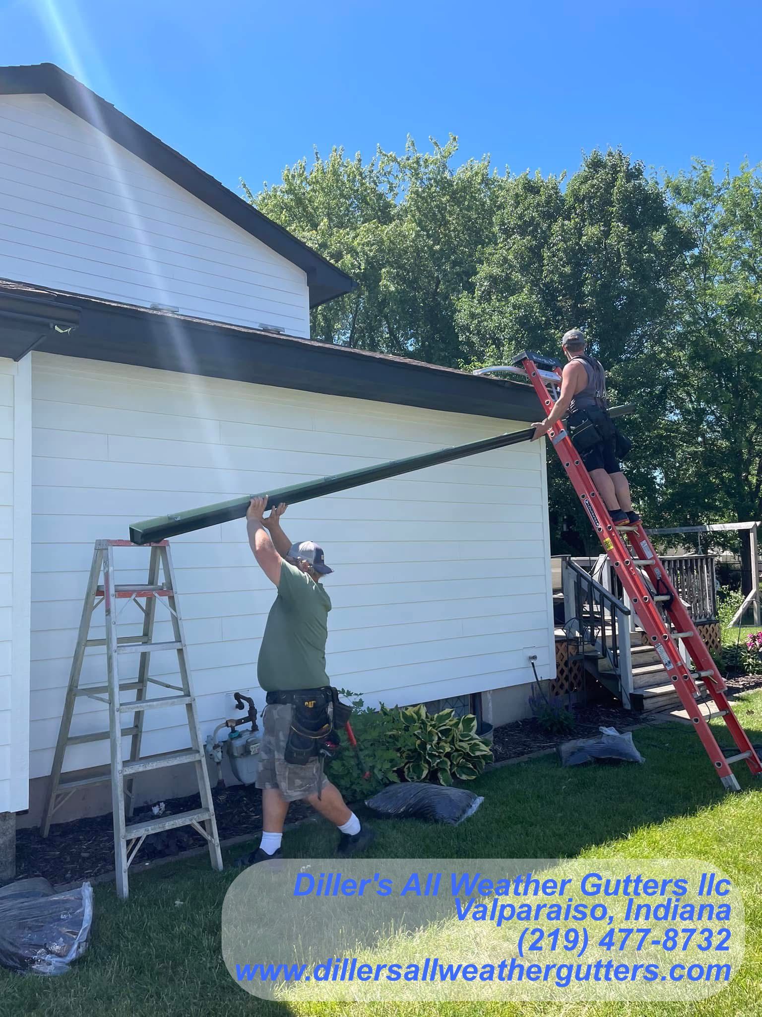Two men are installing gutters for a house.