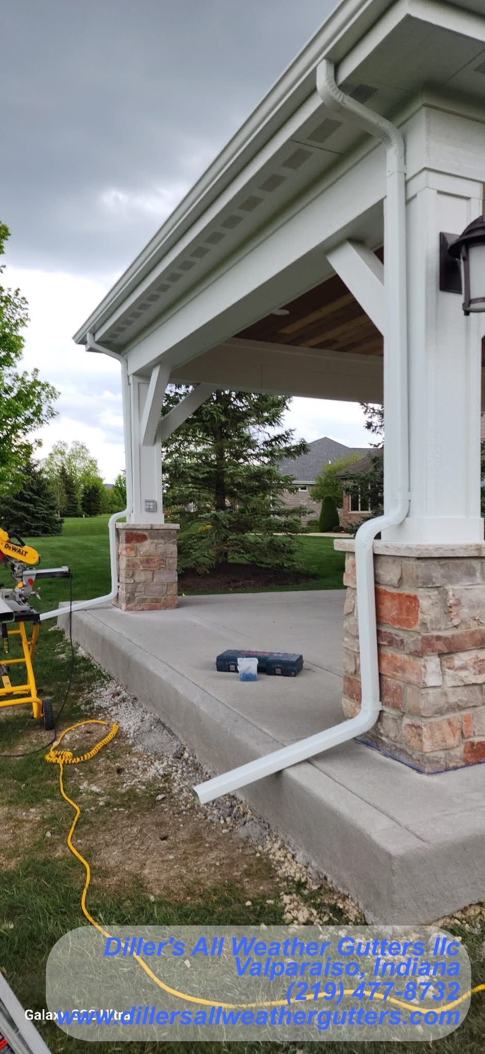 A white gutter is being installed on the side of a house. Gutter Installation in Valparaiso, Indiana