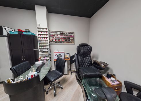 A man is getting his hair cut by a barber in a barber shop.