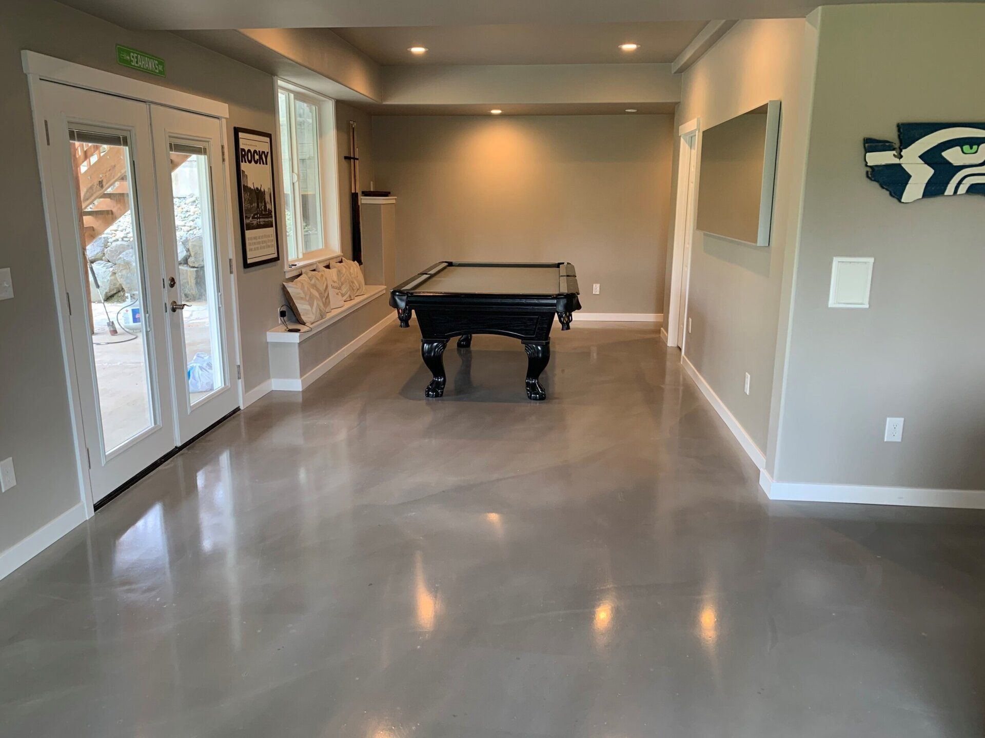 There is a pool table in the middle of the room.