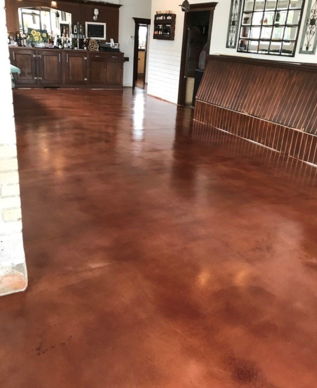 A large room with a concrete floor and a wooden wall.