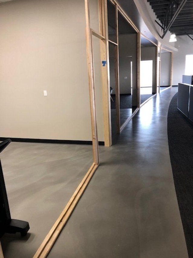 A hallway in a building with a mirror on the wall