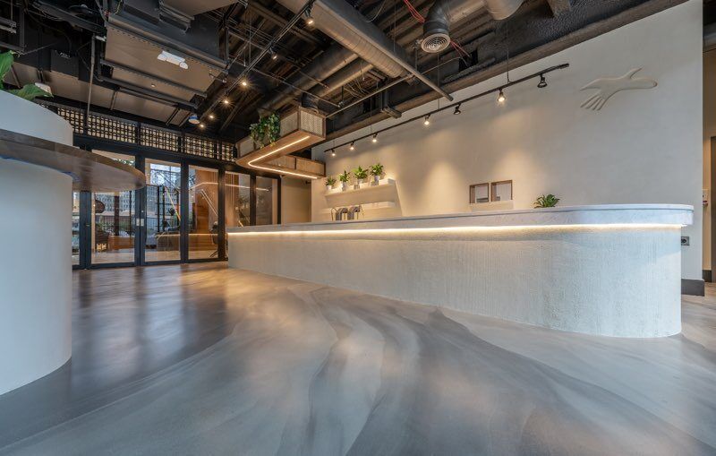 A large empty room with a long counter in the middle of it.