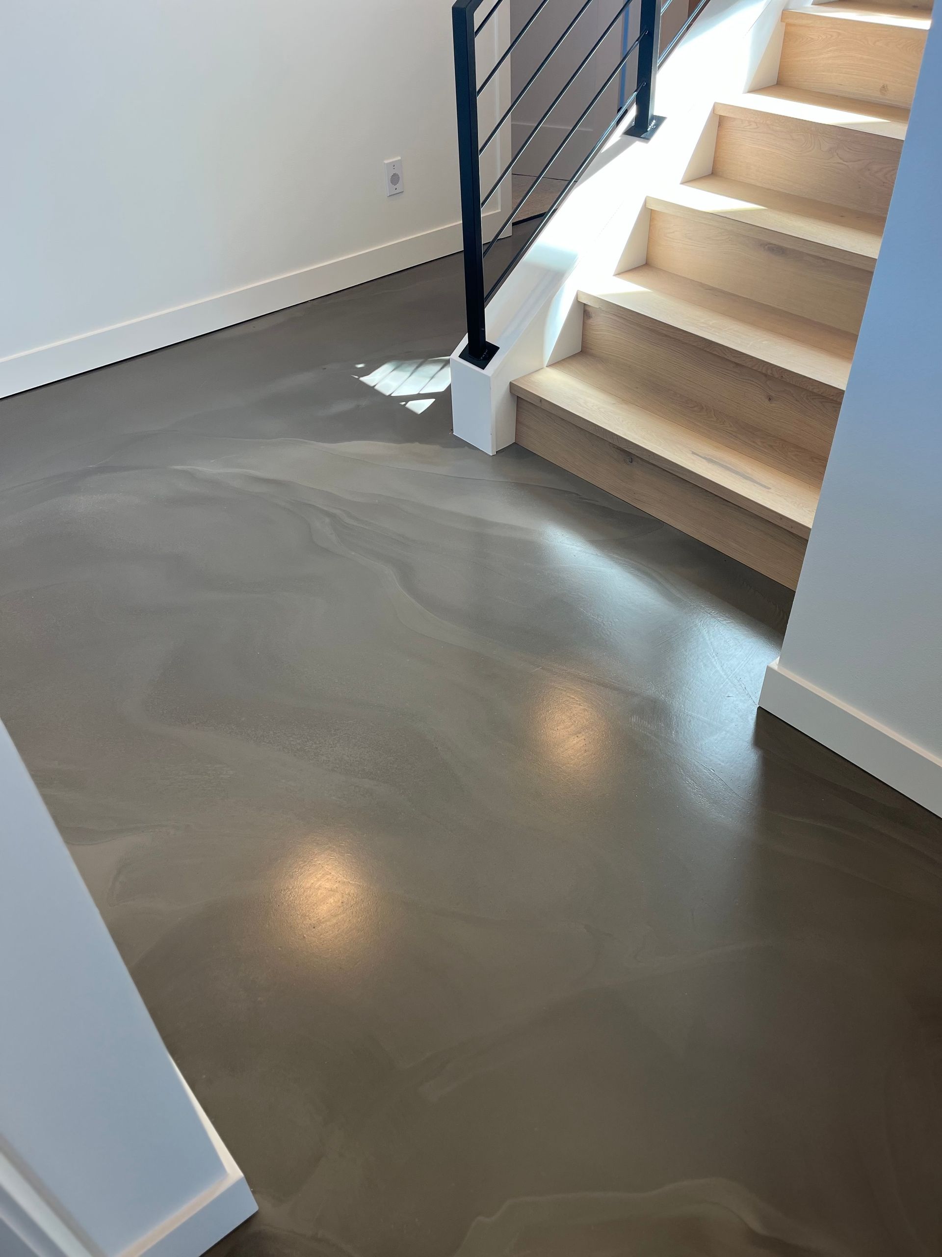 A staircase with wooden steps and a concrete floor