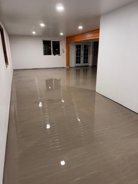 A large room with a shiny floor and white walls