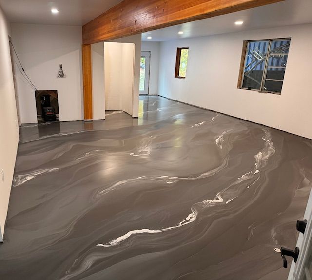 A large room with a gray floor and white walls.