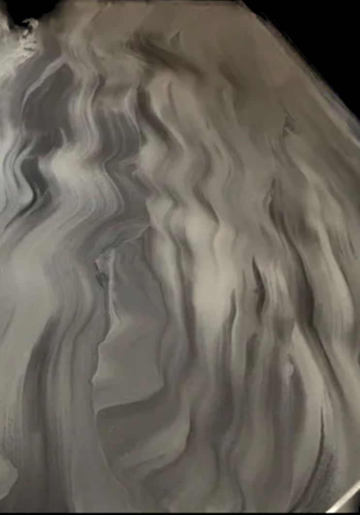 A close up of a bowl of whipped cream on a table.