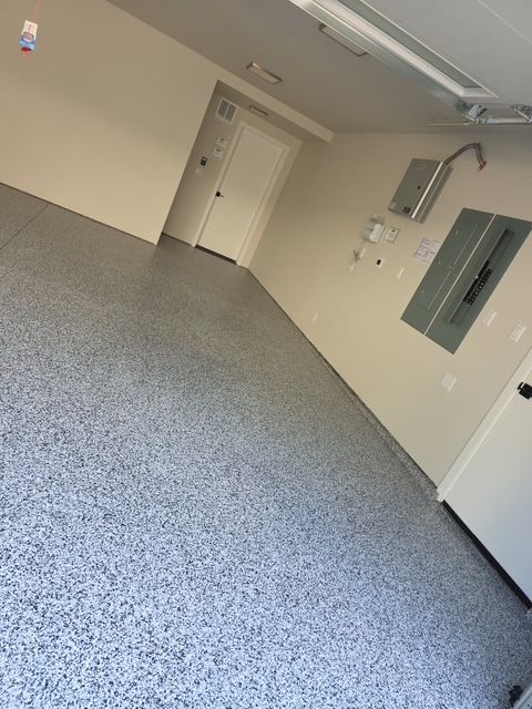 A garage with a gray floor and white walls.