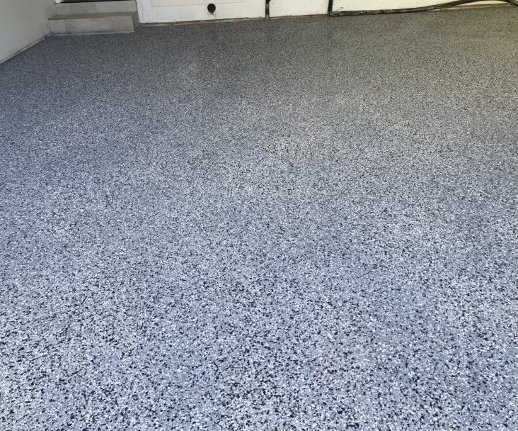 A garage floor with a lot of small stones on it.