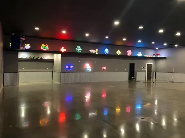 A large empty room with neon lights on the walls