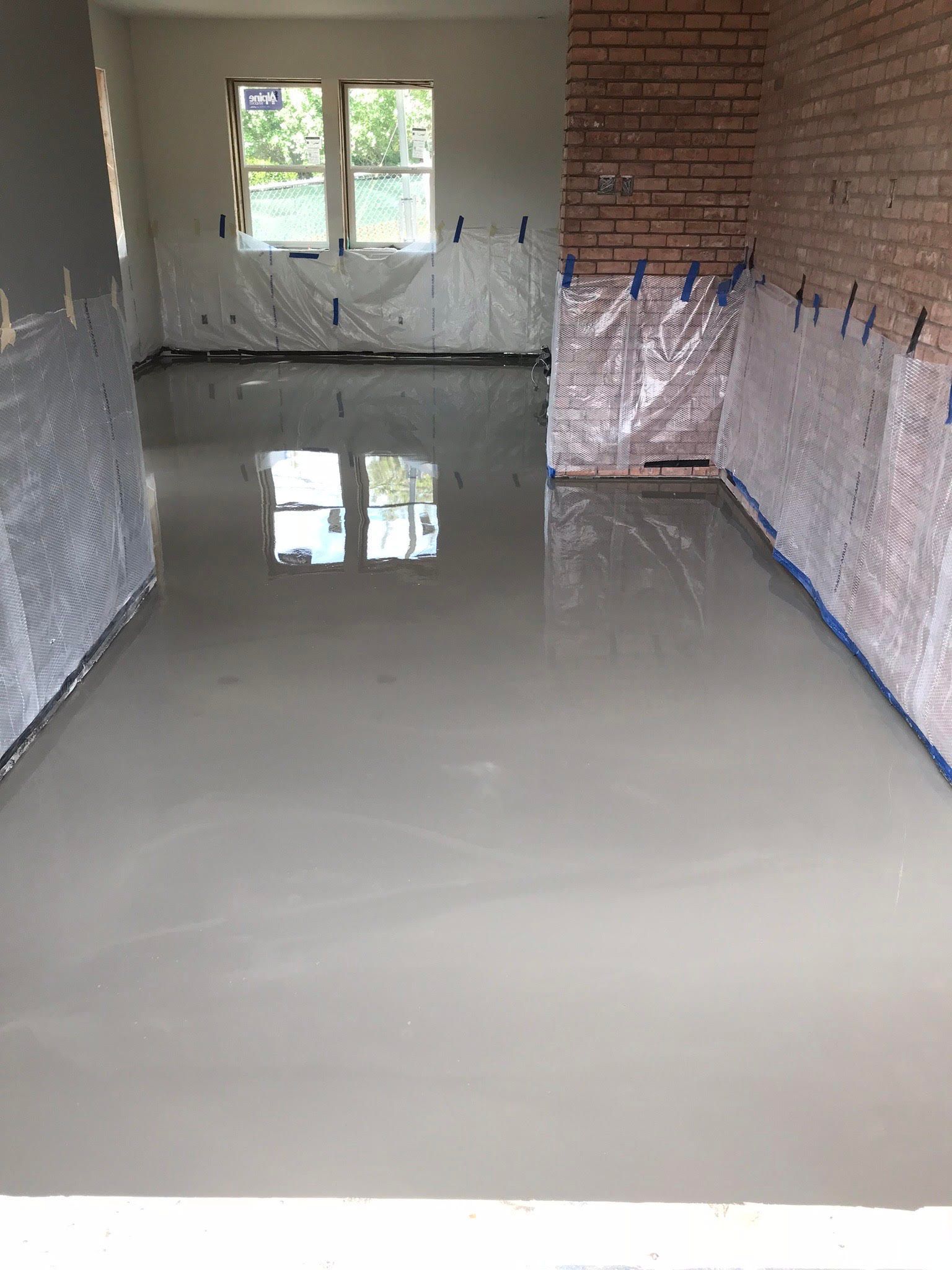 A room with a brick wall and a white floor.