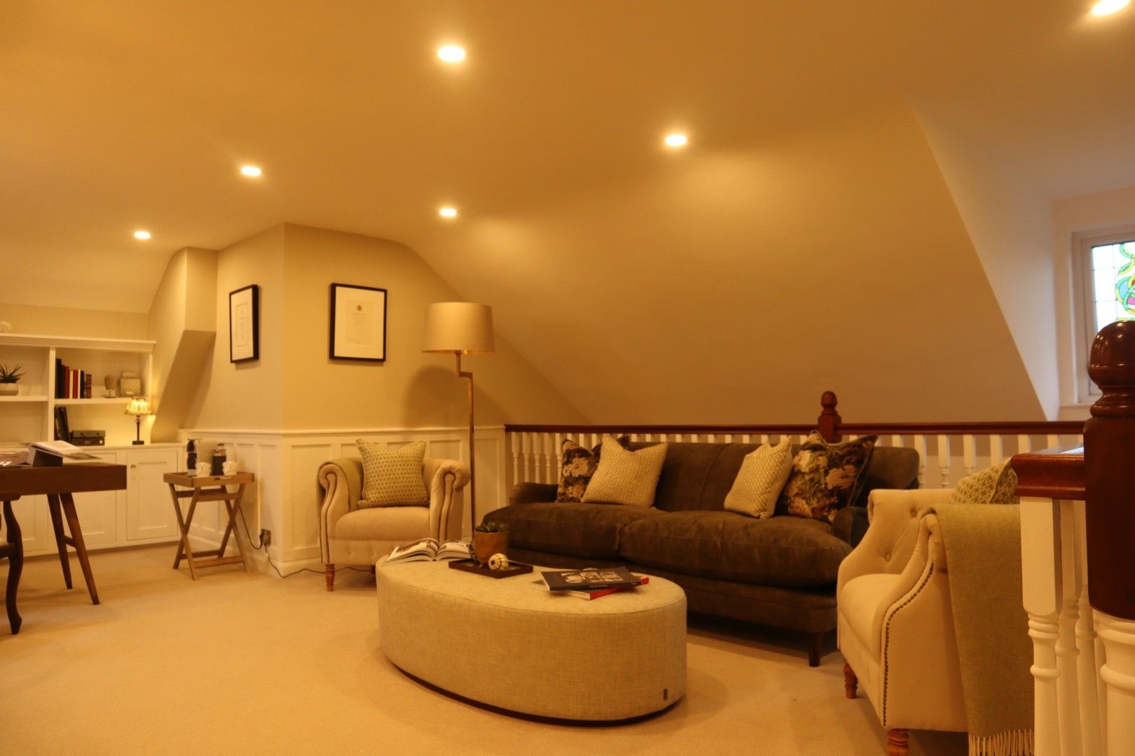 A living room with a couch and chairs and a coffee table