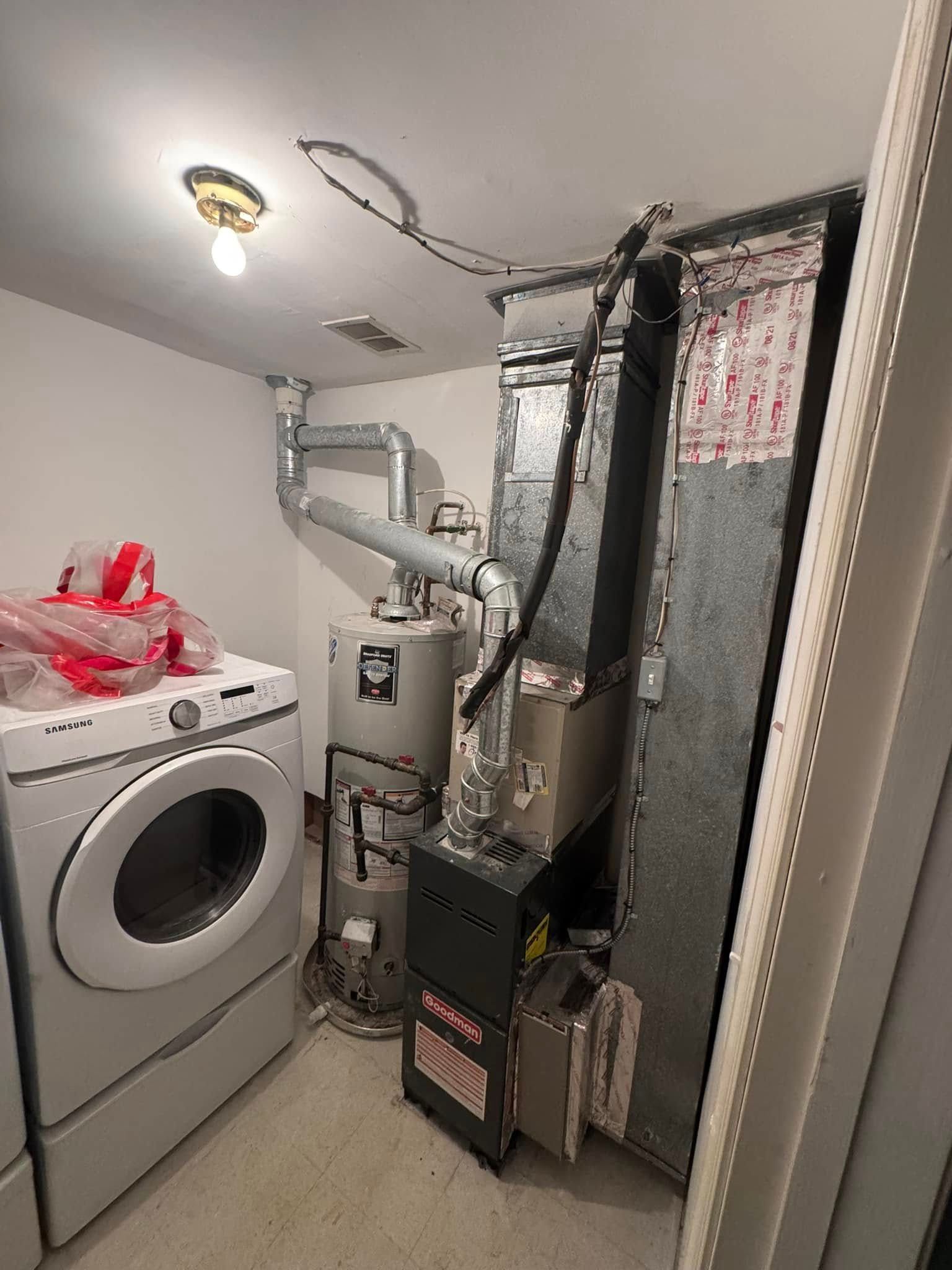 A laundry room with a washer and dryer , a water heater , and a furnace.