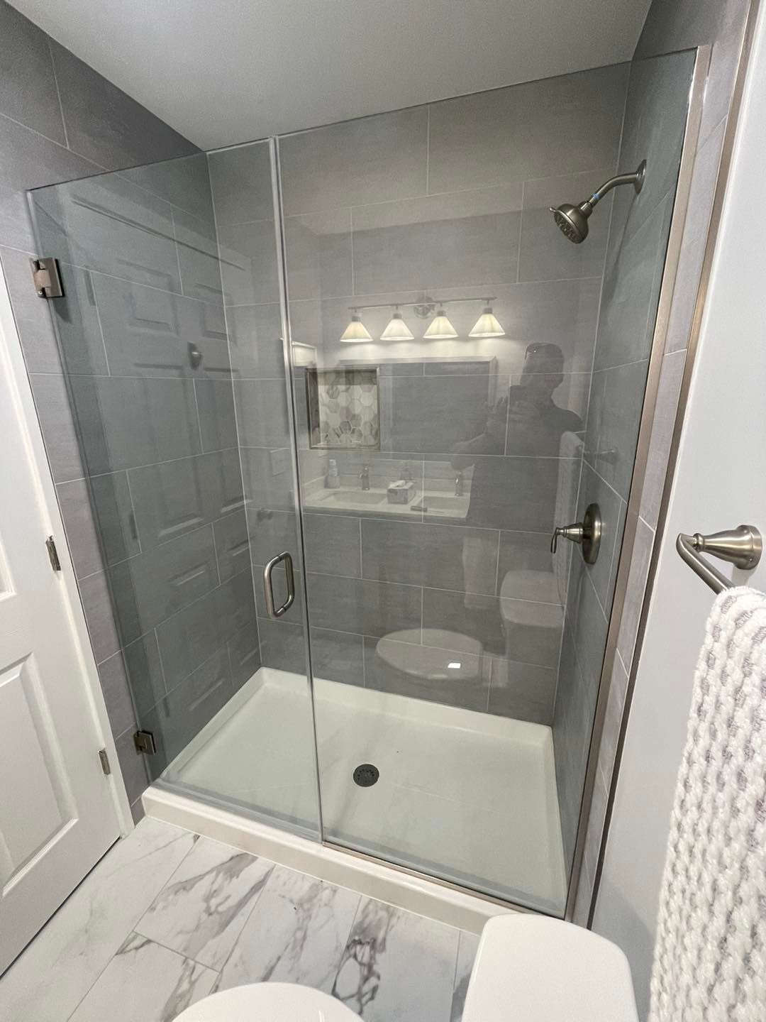 A bathroom with a walk in shower and a toilet.