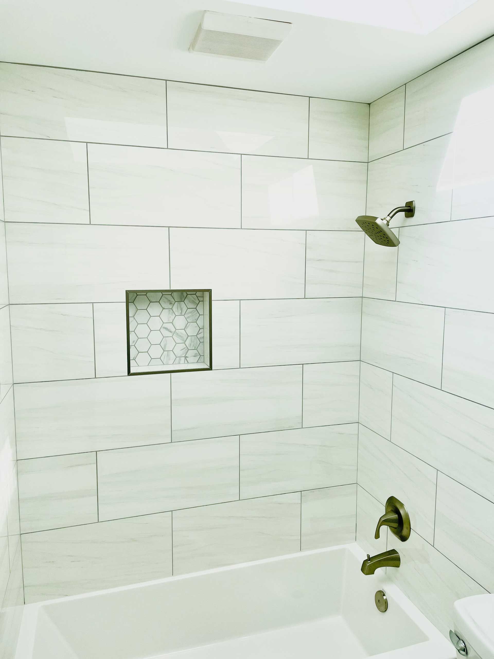 A Bathroom With White Tiles - Oswego, IL - New Bath LLC