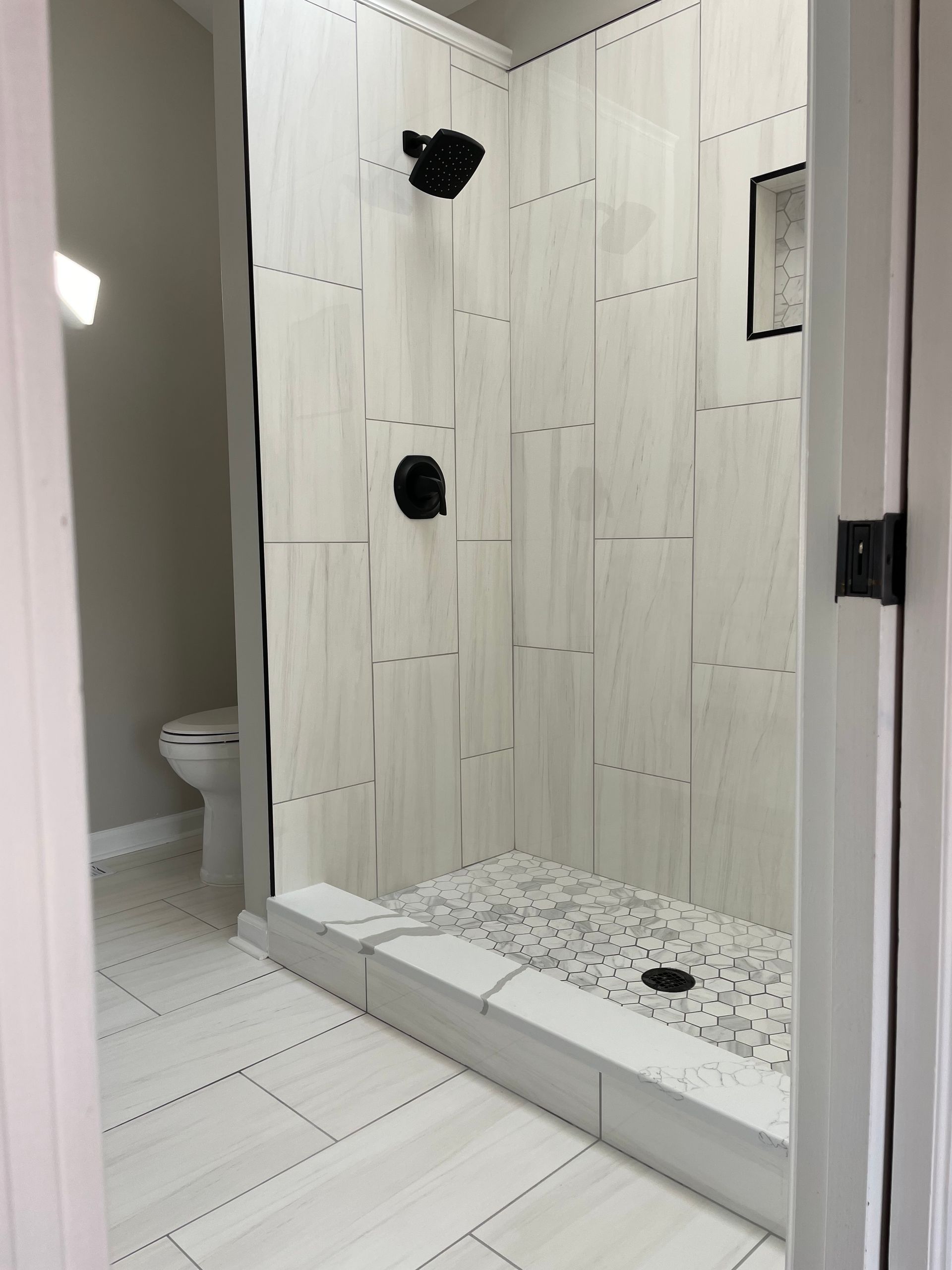 A bathroom with a walk in shower and a toilet