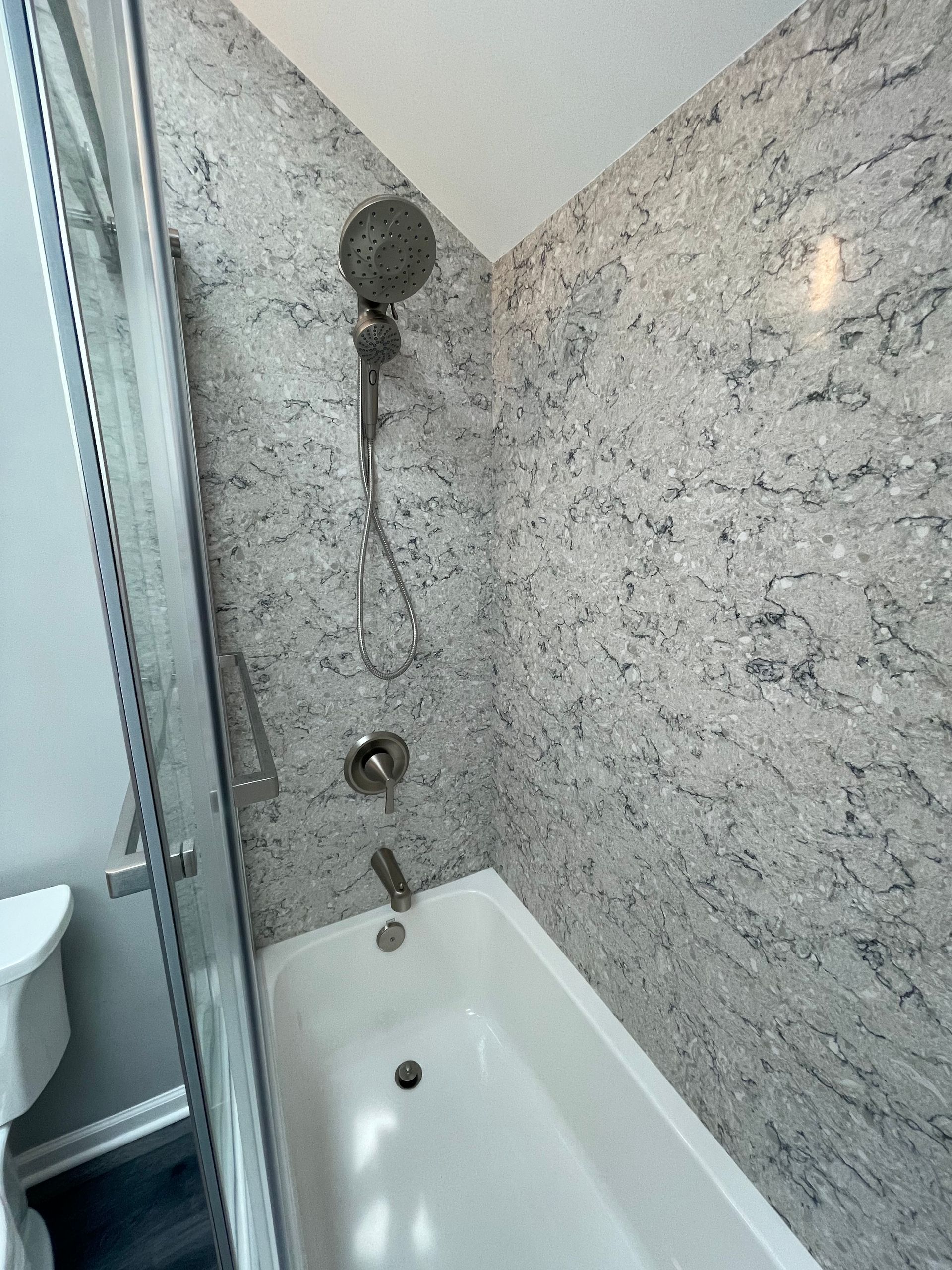 A bathroom with a bathtub and a shower.