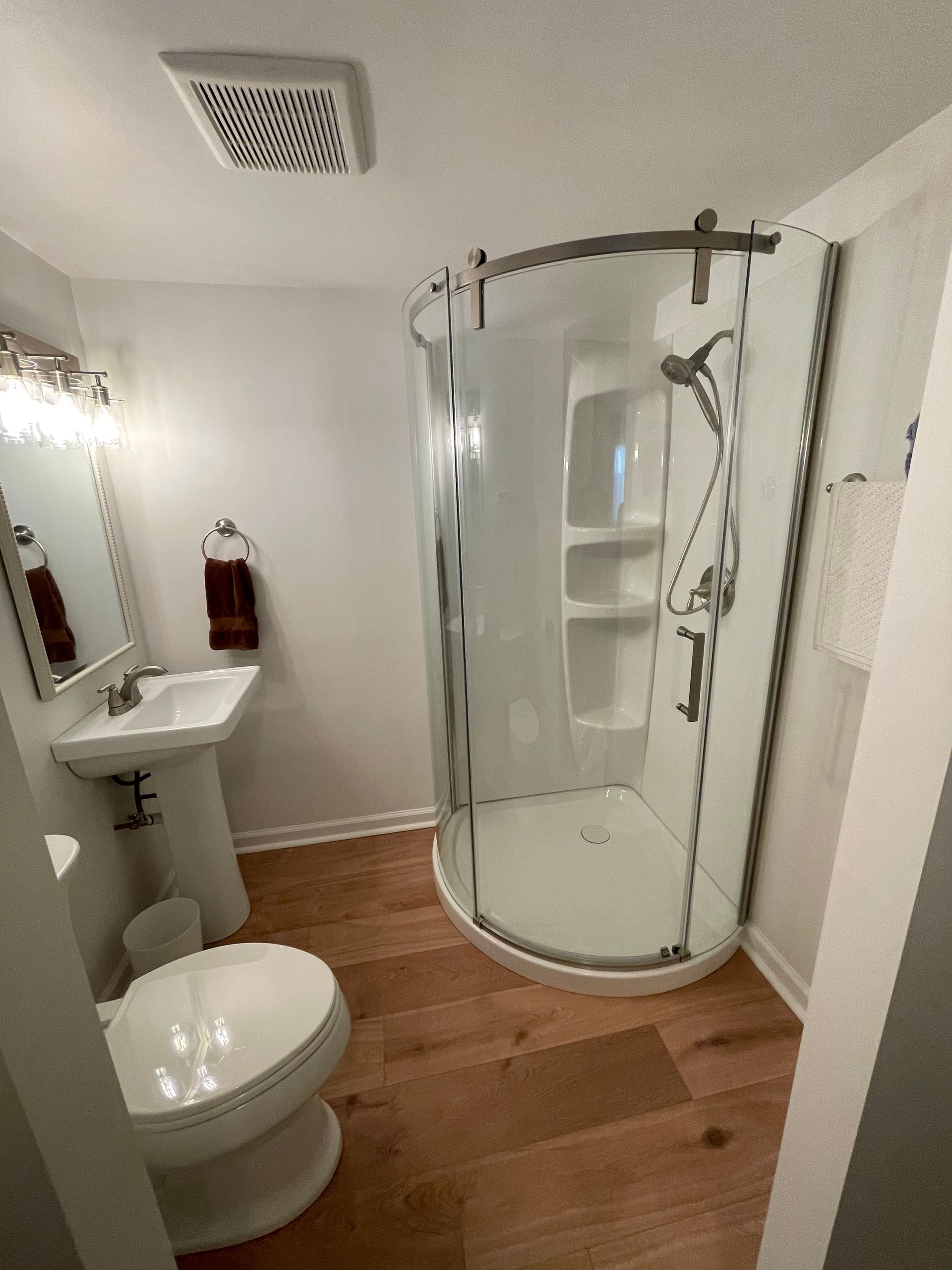 A bathroom with a toilet , sink , shower and mirror - Oswego, IL - New Bath LLC