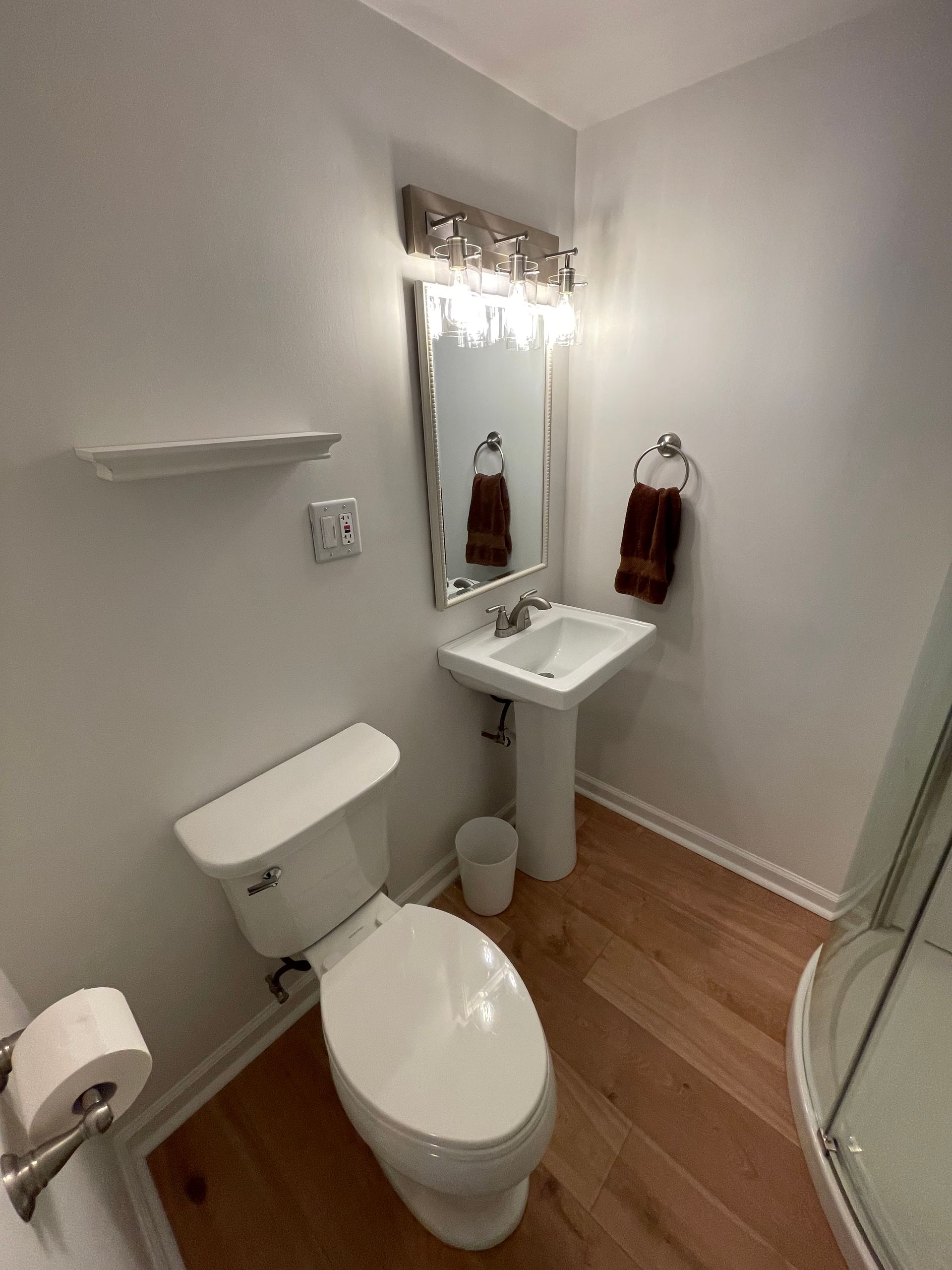 A bathroom with a toilet , sink and mirror - Oswego, IL - New Bath LLC
