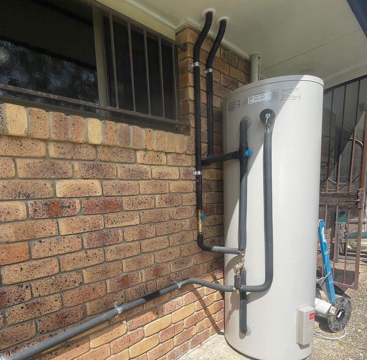 Plumber Checking The Water Heater — Brisbane, QLD — Jim Monger Plumbing and Gas