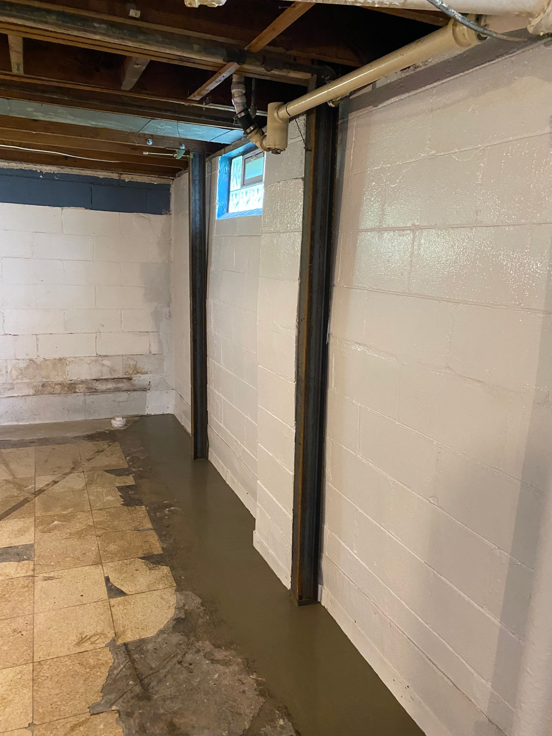 Construction site with concrete block walls, excavation, and a wooden form for a structure.