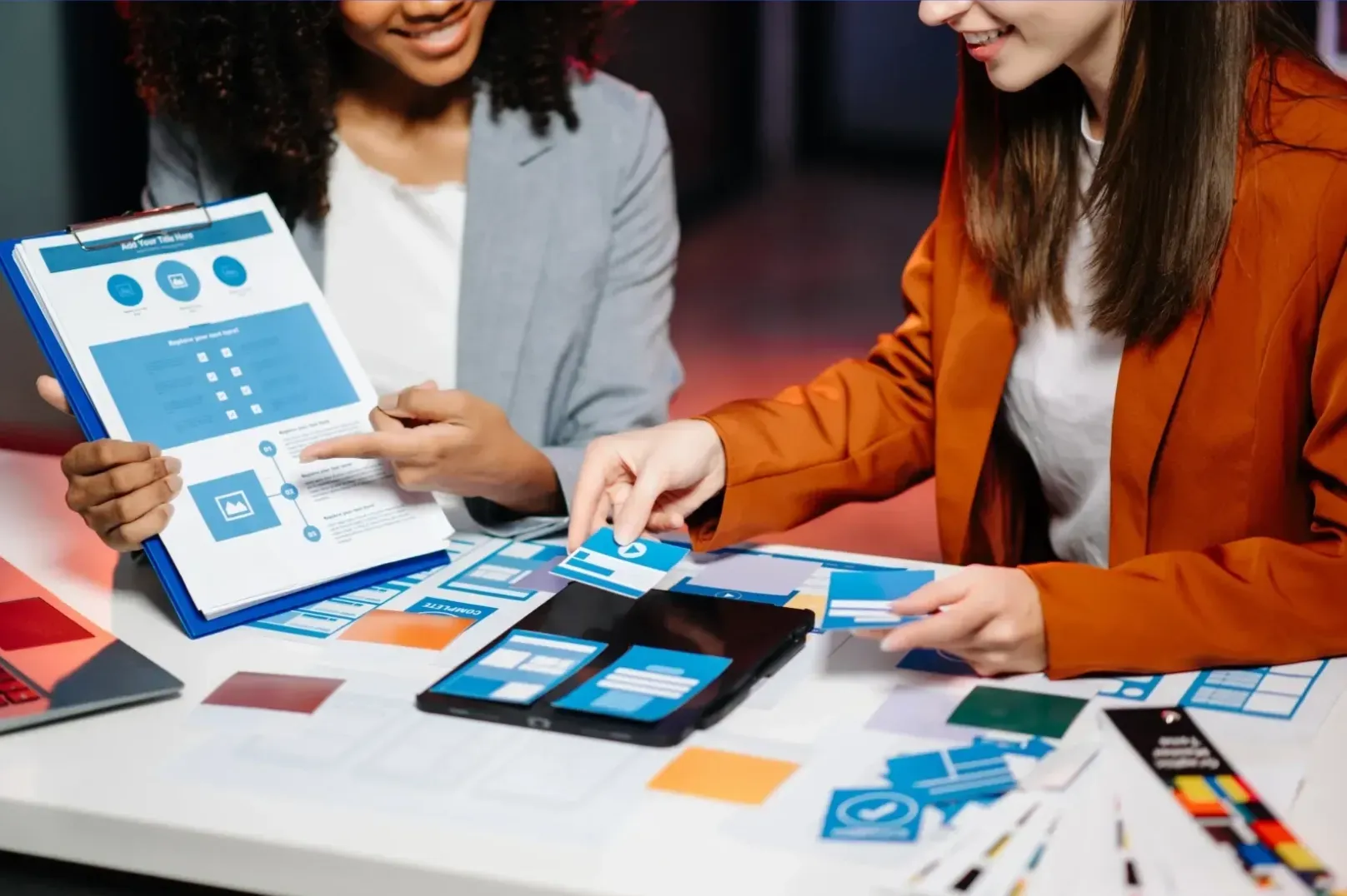 Two people placing cards into holders side by side, representing Tucson SEO strategy planning.
