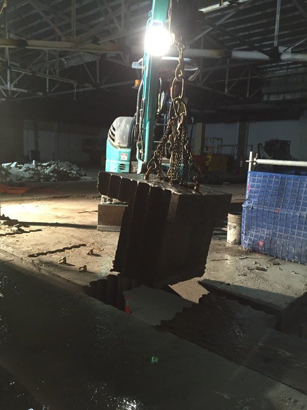 crane helping with building demolition