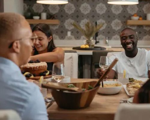 A group of people are sitting at a table eating food.