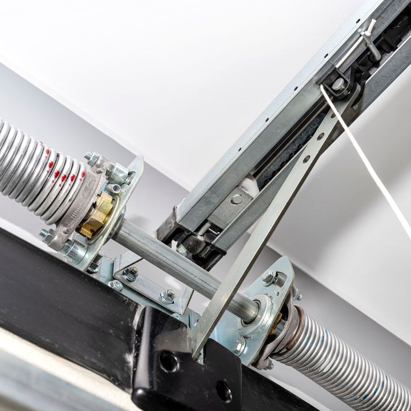 Garage door spring and opener mechanism, silver and black hardware.