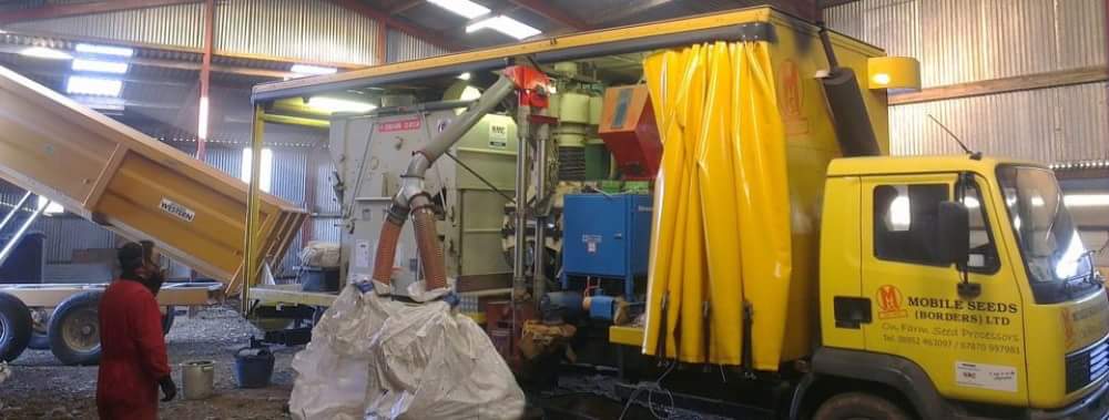 bags of seed attached to seed treatment truck
