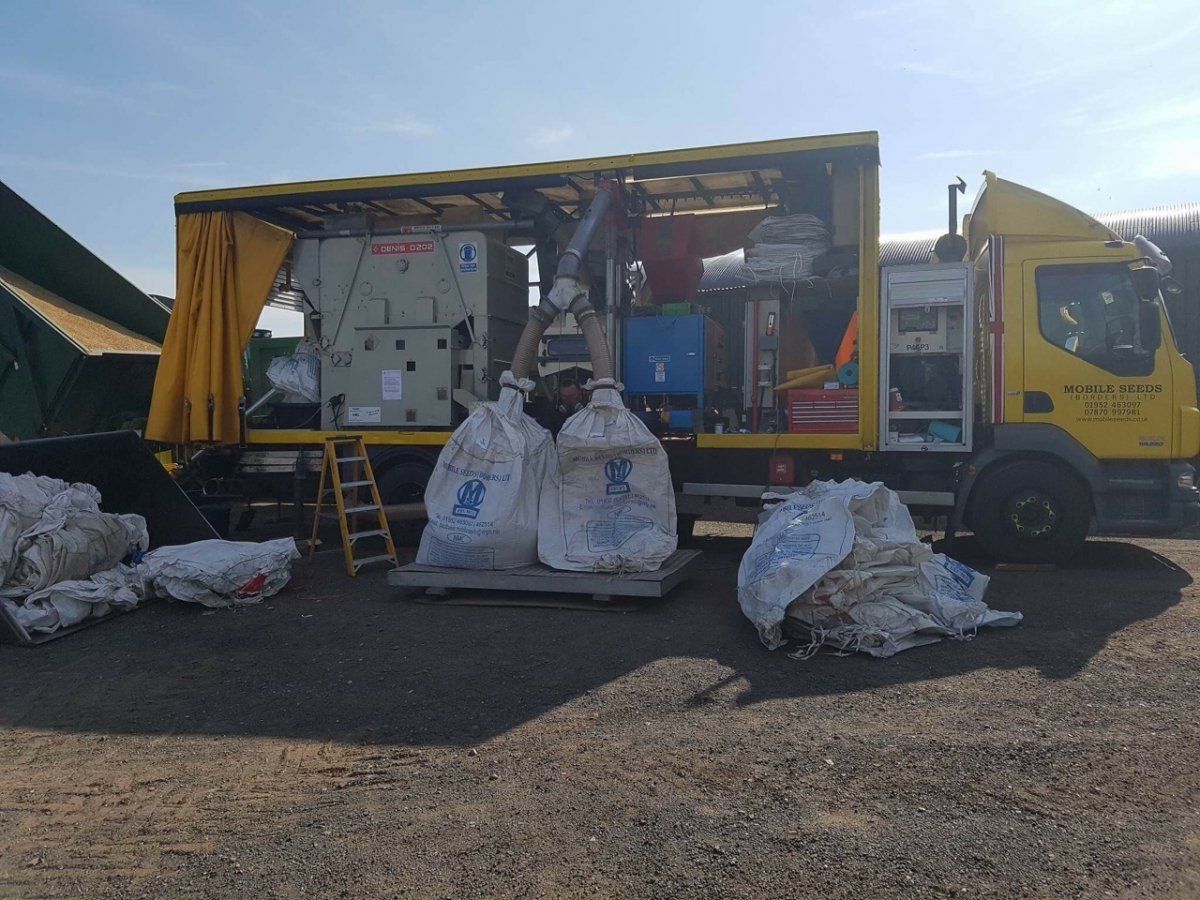 Bags of seed attached to seed treatment truck