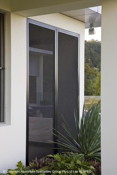 Two black screen doors in a silver frame against a white exterior wall.