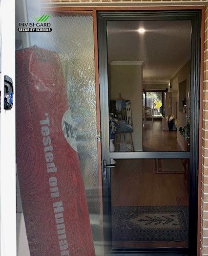A screen door and glass door next to each other. Inside view of a hallway.