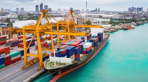 A large container ship is docked at a port.