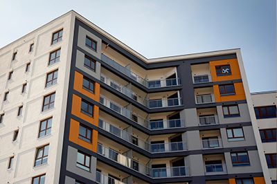 A large apartment building with a lot of windows and balconies.