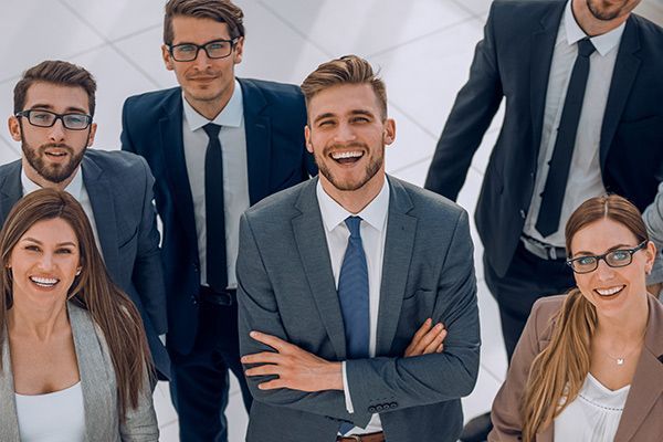 A group of business people are posing for a picture together.