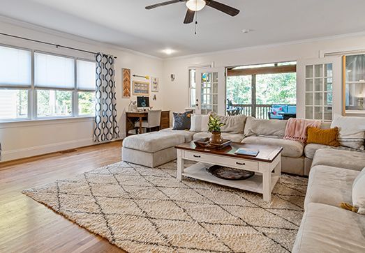 A living room filled with furniture and a ceiling fan.