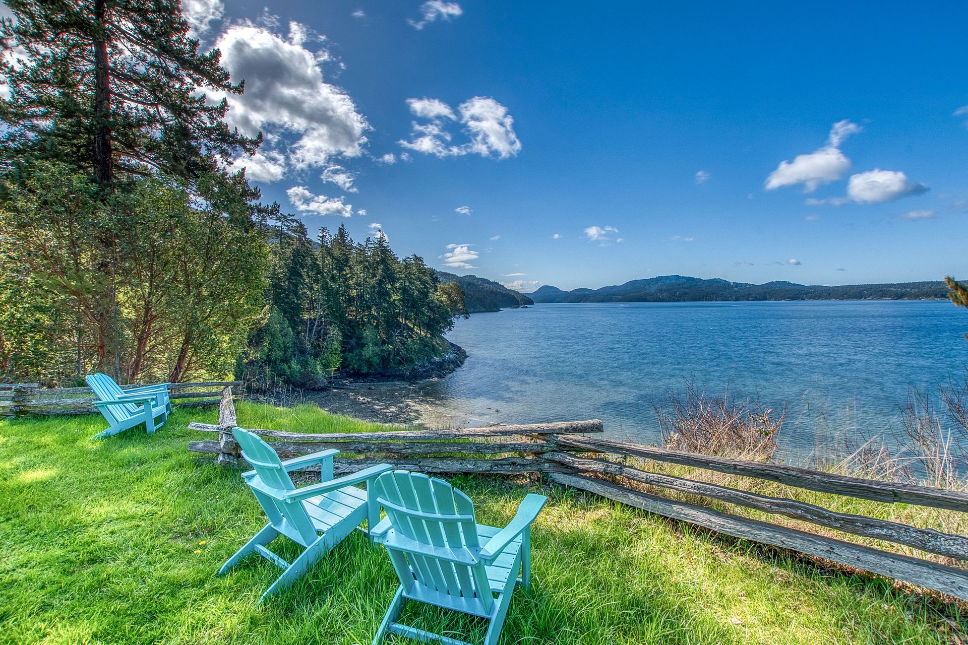 A sunset over a body of water with mountains in the background