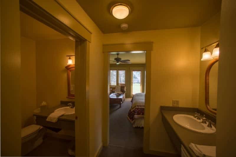 A bathroom with two sinks and a mirror