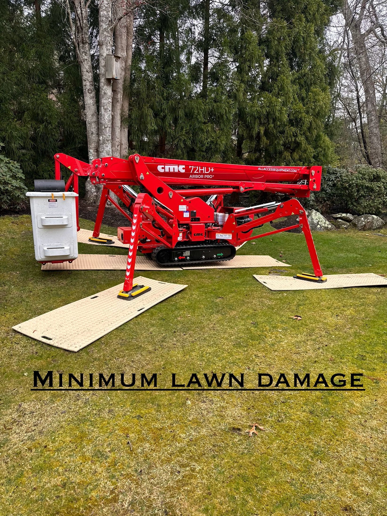 A red crane is sitting on top of a lush green lawn.