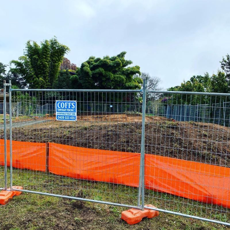 A Fence With A Sign That Says Coffs On It — Coffs Temporary Fencing Pty Ltd In Urunga, NSW