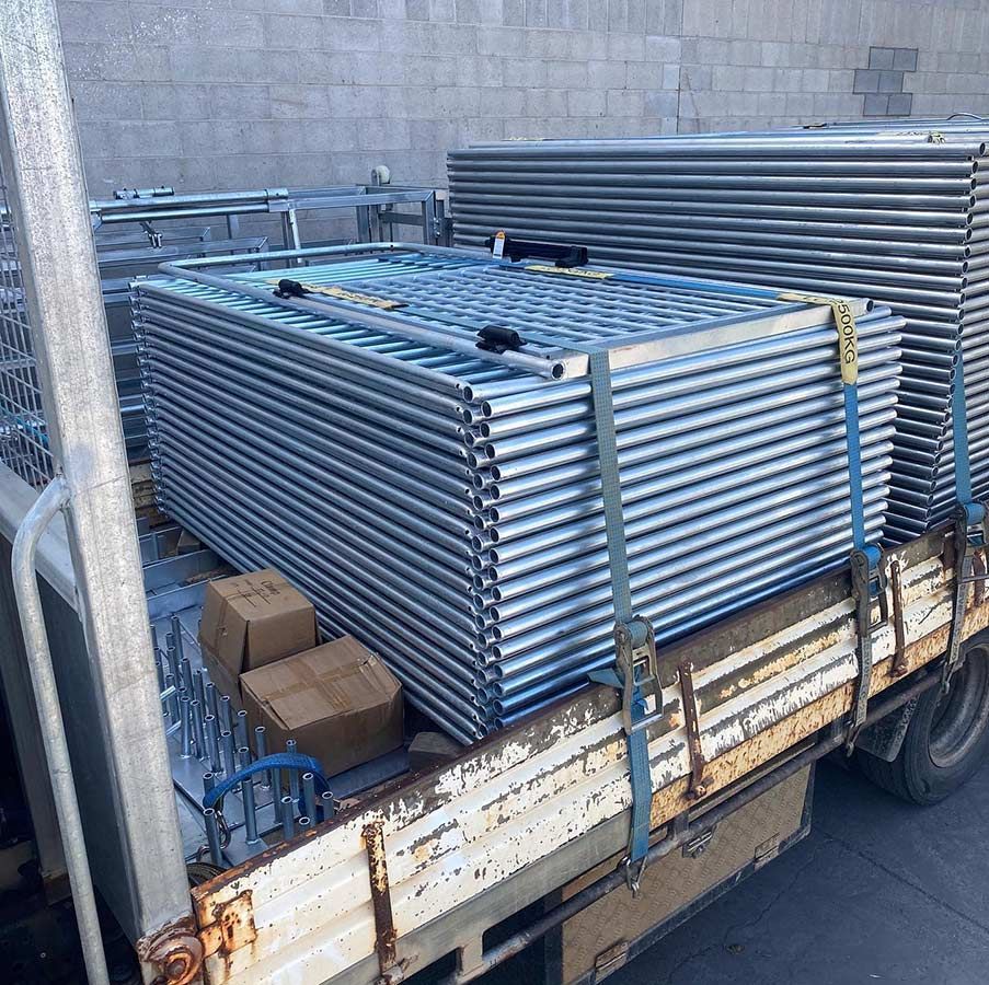A Truck Is Loaded With A Stack Of Metal Scaffolding — Coffs Temporary Fencing Pty Ltd In Moonee Beach, NSW